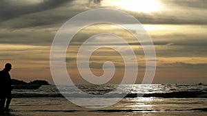 Seascape at sunset reflected on wet beach sand with incoming waves