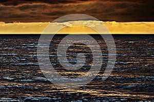 Seascape at sunset with stunning nimbostratus cloud formation over the Baltic sea.