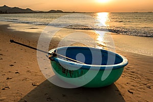 Seascape with Sunshine on A Coracle - Traditional Vietnamese Fishing Boat on Sandy Beach at Sunrise