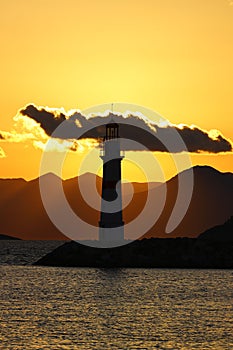 Seascape at sunshine. Lighthouse and sailings on the coast. Seaside town of Turgutreis and spectacular sunshine