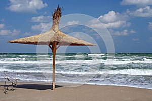 Seascape. Thatched umbrella. Summer, sea, sun, holiday, waves, fun, beach - Black Sea, landmark attraction in Romania