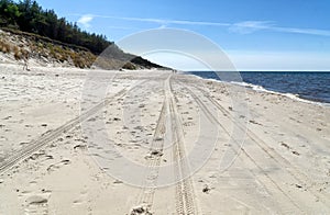 Seascape. Tire tracks on the beach sand. Baltic sea coast, Western Pomerania, Poland, Europe
