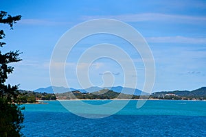 A seascape with turquoise water and islands in the distance. Winter vacation in Thailand