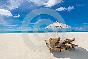 Seascape with two chaise lounges, without people. Beautiful beach ocean vacation destination scene