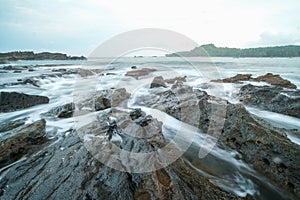 seascape is very beautiful with coral rocks and sea water that looks very soft like cotton at Sawarna Beach, Indonesia. slow