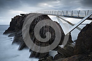 Seascape view of the long walkway of Las Gaviotas viewpoint located in Castrillon, Asturian coast, Spain photo