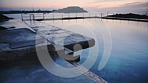 Seascape view of an outdoor swimming pool, in the Guernsey coastline,