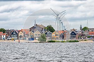 Seascape village Urk with wind turbines raising above the houses photo