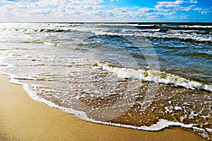 Seascape with waves breaking on the beach.