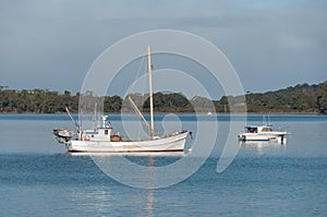 Seascape with white fishing boat and yacht. Summer recreation background