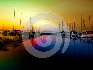 A seascape of yachts moored in a harbour at night