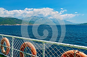 seascapes, view from deck of ship with lifebuoy, the Bay of Kotor during a cruise on a ship in Montenegro, a bright sunny day,