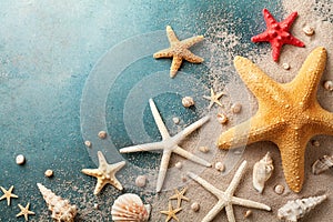 Seashell, starfish and beach sand on blue background. Summer holiday concept. Top view and flat lay