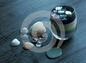 Seashells, glass rocks stones, marbles, and colorful sand decorations