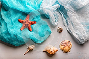 Seashells and starfish on cian and white cloth