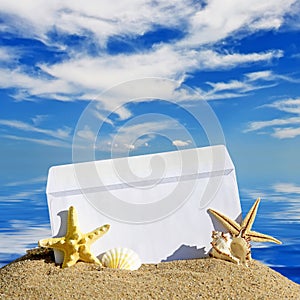 Seashells and starfish with open envelope with blank letter