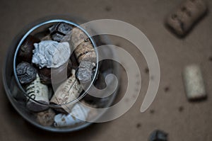 Seashells, wine corks, chestnuts and cones in glass wine