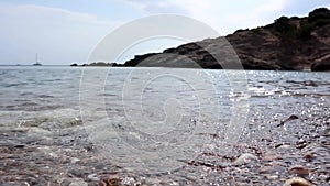 Seashore clear water closeup sun beaming in Greece