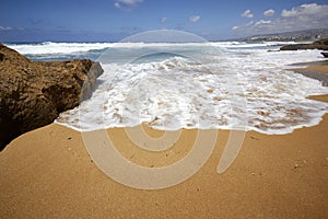 Seashore foam spume wave in the sand