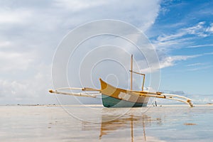 Seashore low tide with old boat front view