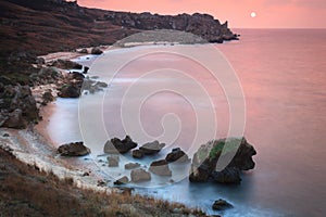 Seashore with misty water at sunset