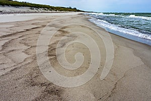 Seashore after rain, wet sea sand, deserted sea beach
