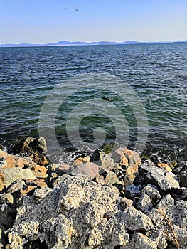 seashore with a stone embankment. The coast of the Black Sea. Embankment alley for walks.