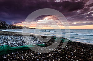 Seashore Sunset With Fishnets On The Sand