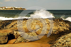 Seashore waves crash against the rocks