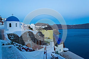 Clifftop evening view of Oia and Caldera Santorini Greece