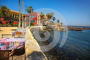 Seaside dining setup with colorful tablecloths on Goree Island, Senegal photo