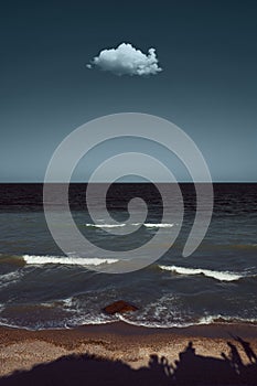 Seaside image with a singular cloud above