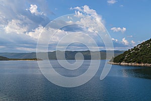 Seaside landscape in Uvala-Duboka in Croatia. Sea, mountains and blue sky with clouds in the background photo