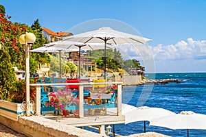 Seaside landscape - view of the cafe on the embankment by the sea, in the Old Town of Nesebar