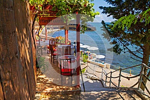 Seaside landscape - view of the cafe on the embankment by the sea, in the Old Town of Nessebar