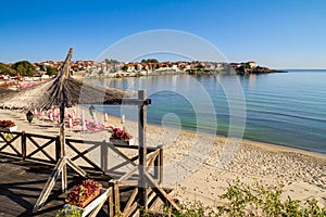 Seaside landscape - view of the cafe and the sandy beach with umbrellas and sun loungers in the town of Sozopol