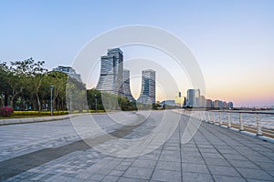 Seaside Plaza and modern buildings, city skyline of Xiamen Shipping Center at dusk