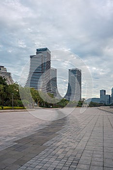 Seaside Plaza and modern buildings, city skyline of Xiamen Shipping Center at dusk