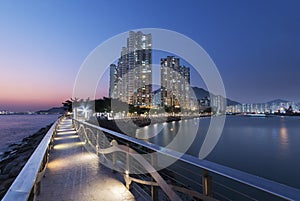 Seaside promenade and high rise residential building in Hong Kong city