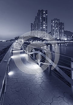 Seaside promenade and high rise residential building in Hong Kong city