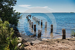 Remains of the pier and pillars in the ocean water