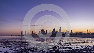 Seaside skyline of Kuwait city from night to day timelapse