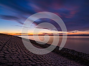 A seaside sunset during sunset. A long exposure photo. Landscape during a bright sundown.