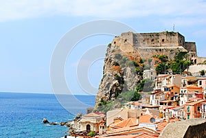 Seaside town Scilla with castle on rock Castello Ruffo. Mediterranean Tyrrhenian sea coast. Scilla, Calabria, Italy. July 2019
