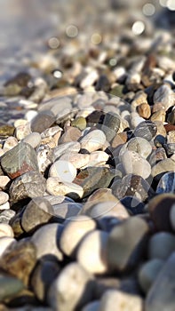 Seaside waves roll over pebbles on beach.