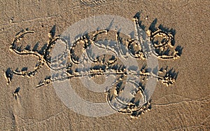 Seaside written in sand