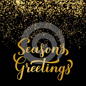 SeasonÃ¢â¬â¢s Greetings calligraphy hand lettering on shiny gold sparkles background. Merry Christmas and Happy New Year typography