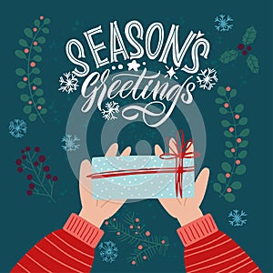 Season`s greetings. Gift in hand. Xmas card. Merry Christmas and Happy new year 2021.