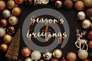Season`s greetings text, handwritten golden sign at christmas go photo