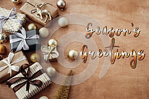 Season`s greetings text, handwritten golden sign at christmas st